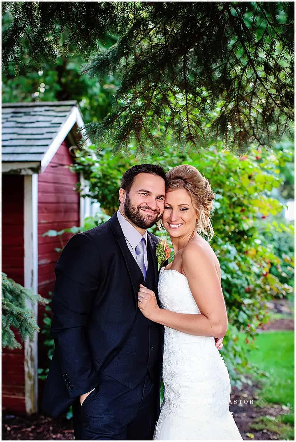 bride and groom on farm in fall after wedding
