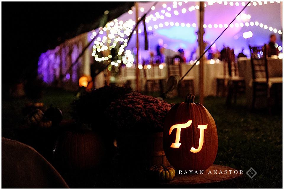 tent wedding with string lights and pumpkins with candles