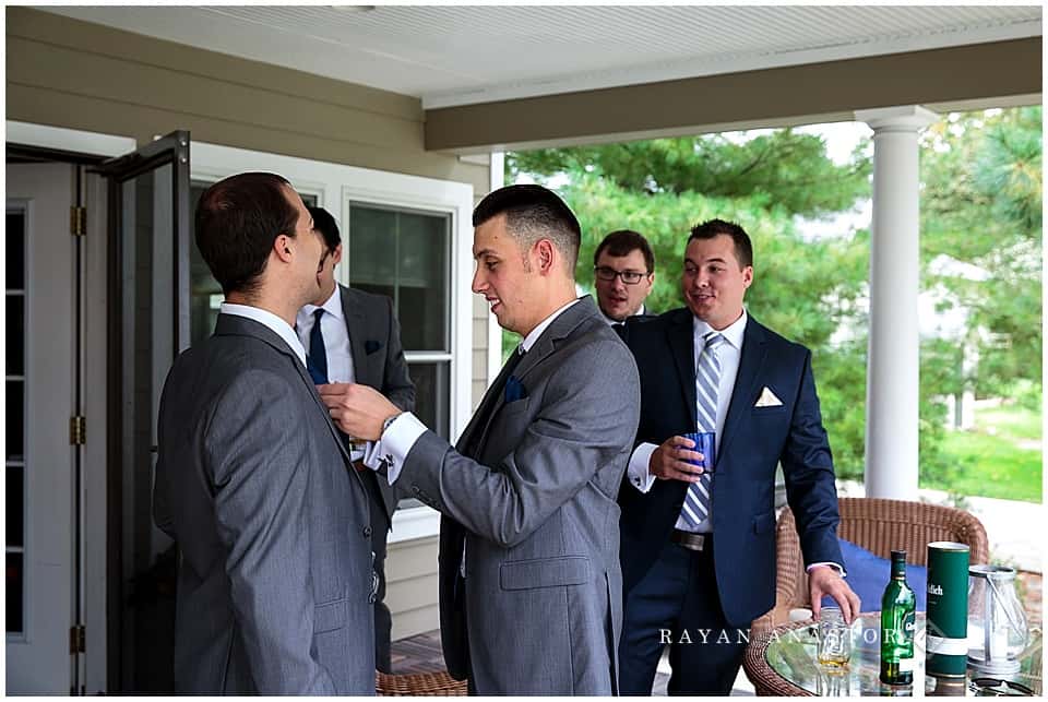 guys tying ties for wedding