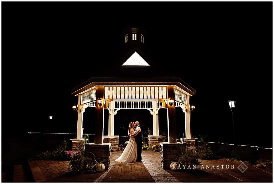 night time photo of bride and groom in gazebo 