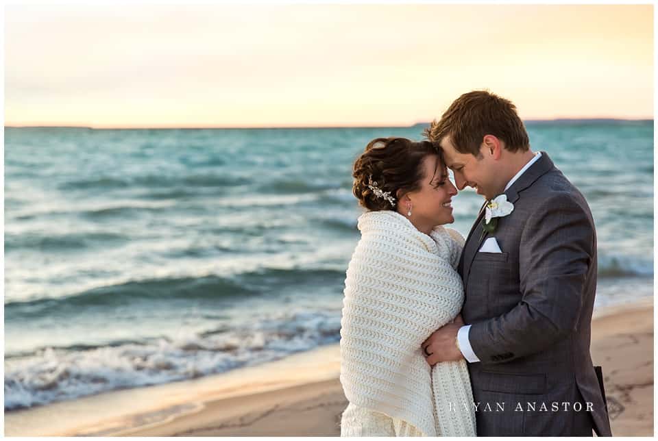 Bride and groom at sunset on lake michigan