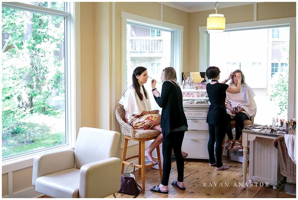 bride having hair and makeup done at the Lily Jade Salon