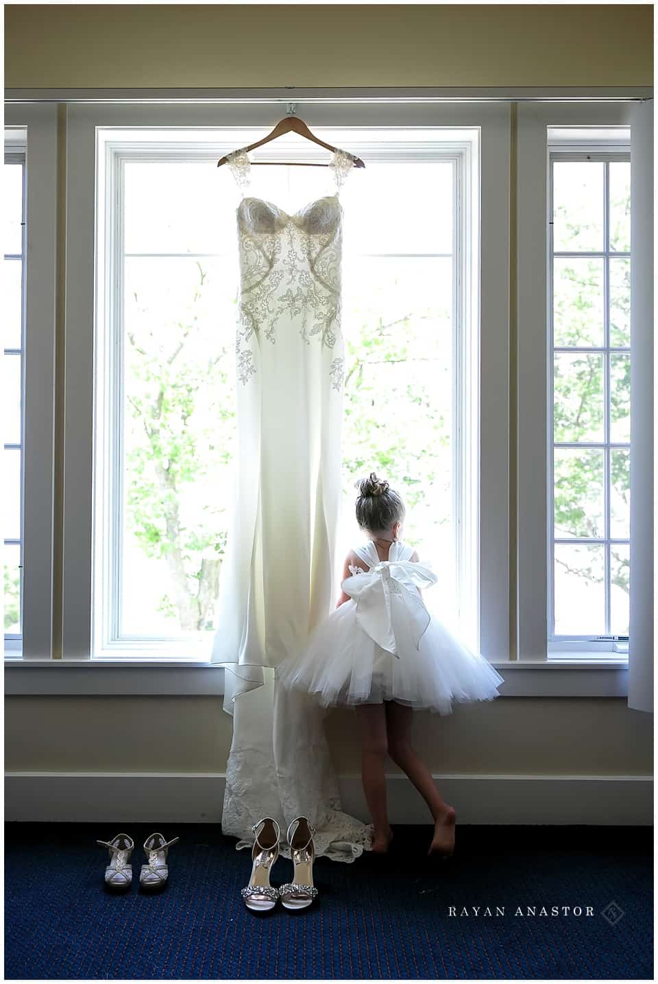 bride's daughter dressed and waiting with her moms dress