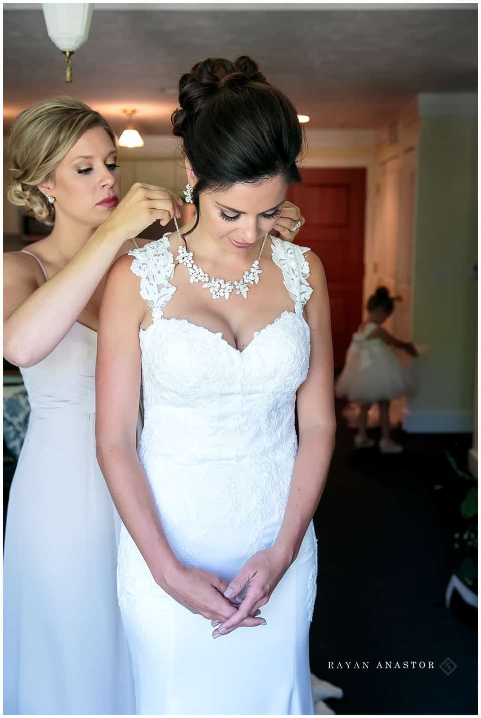 bride having necklace put on