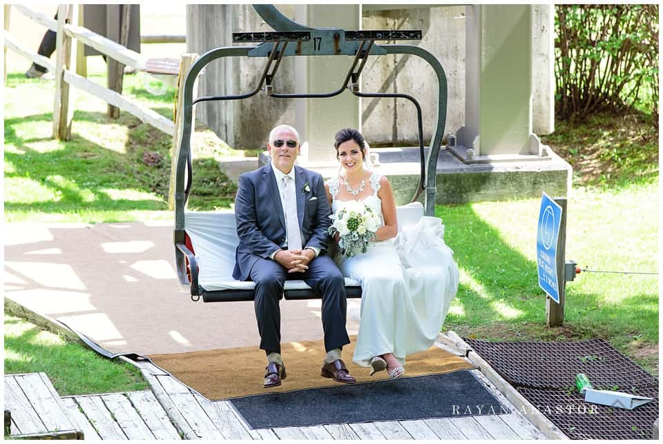 bride and her father on chair lift heading to the wedding