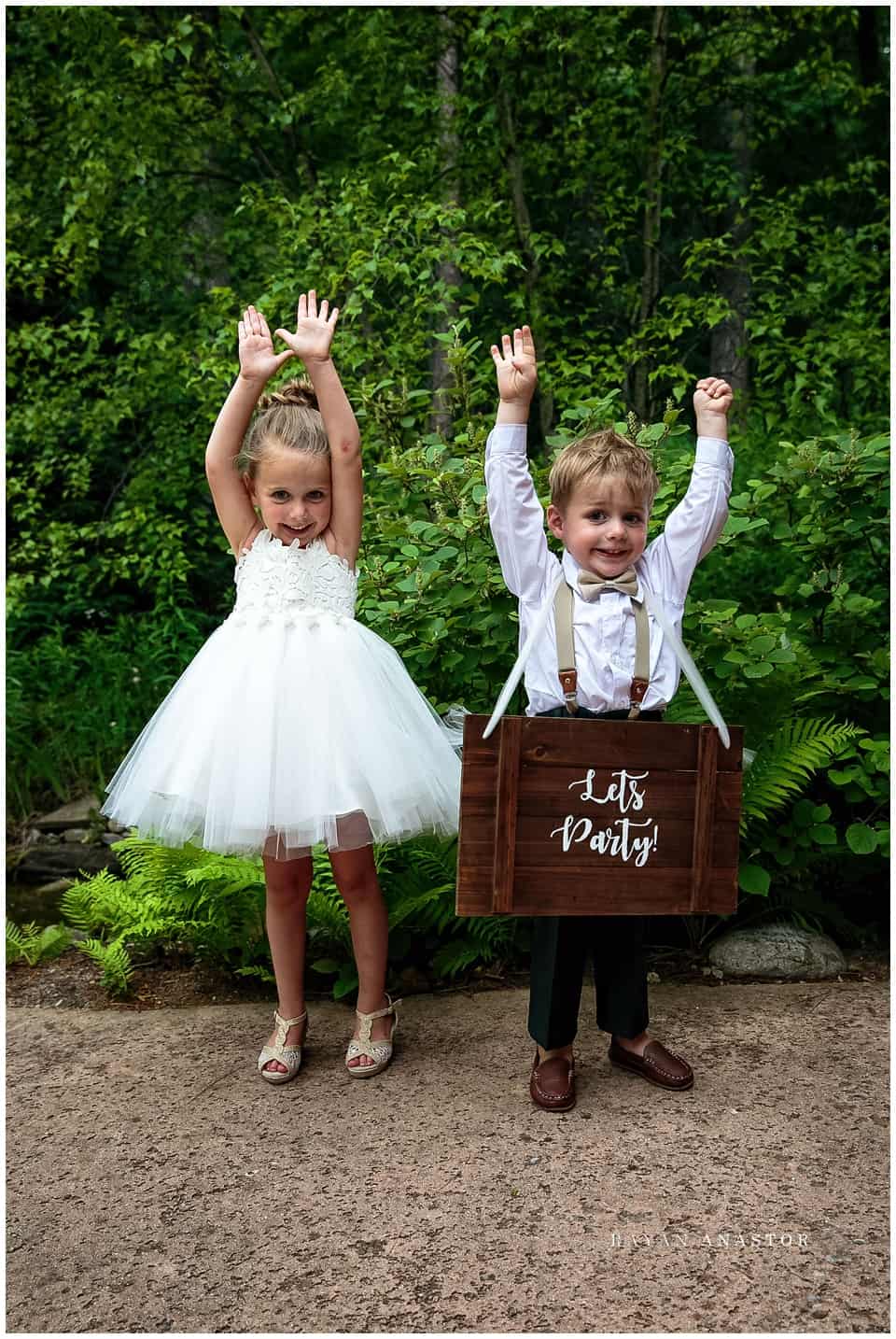 flower girl and ring bearer with lets party sign