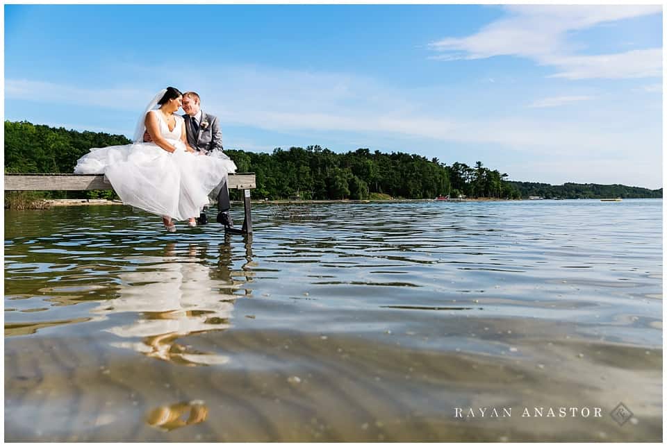 bride and groom over water on grand traverse bay