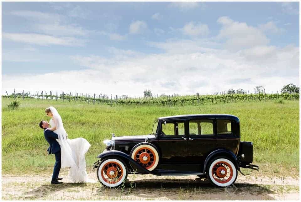 Bride and Groom with Model A car at vineyard