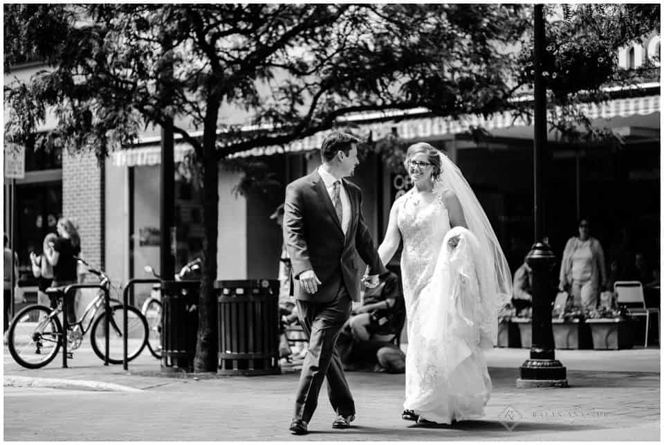 bride and groom crossing street in Traverse City