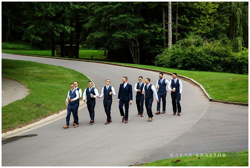 groom and groomsmen walking down street