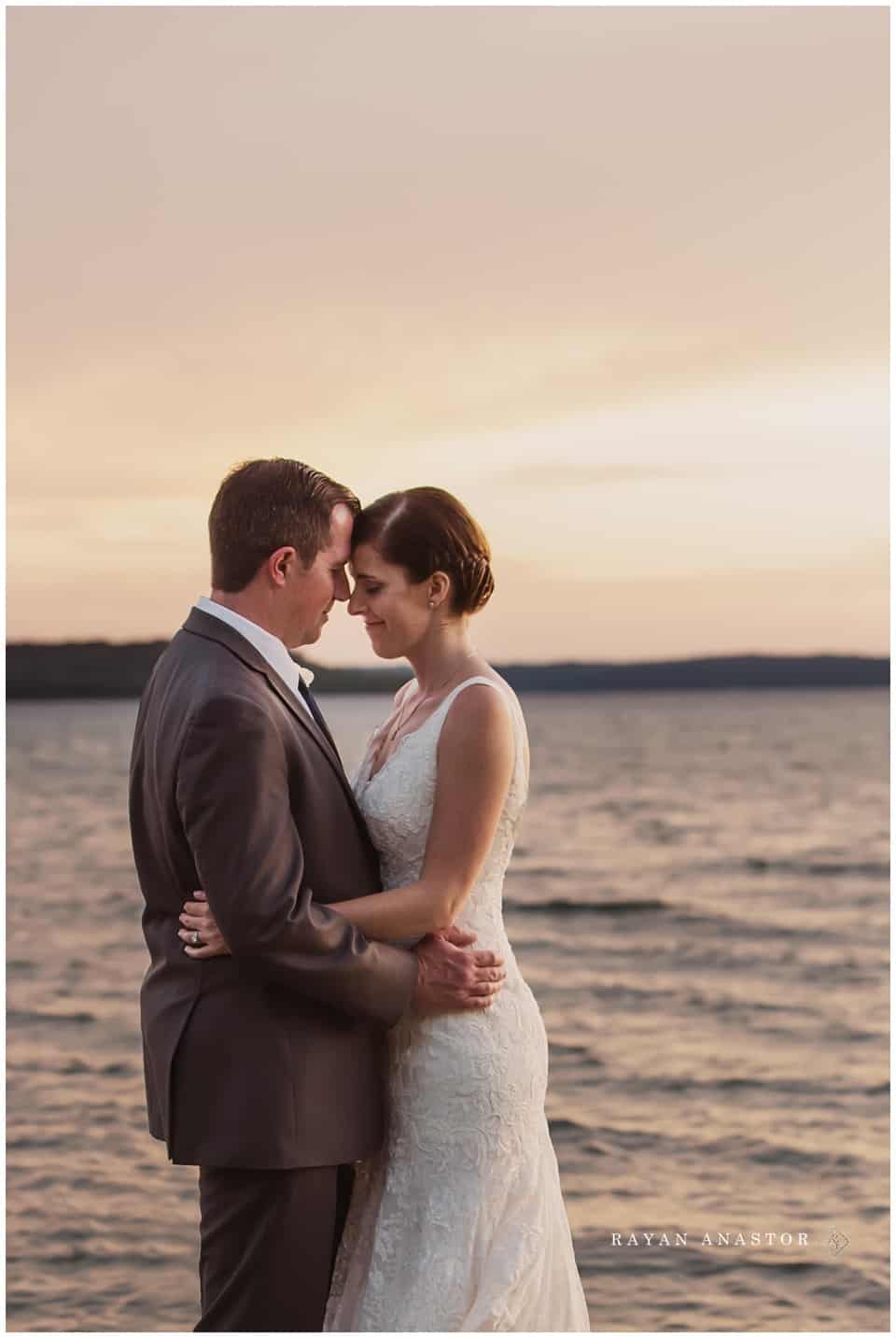 bride and groom at sunset on grand traverse bay