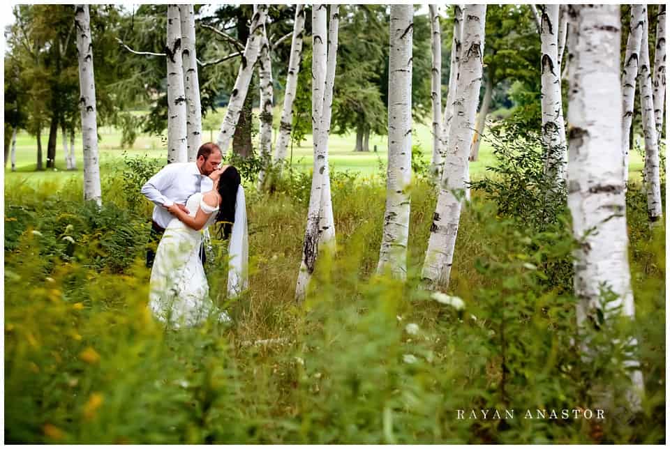 bride and groom among the birch trees