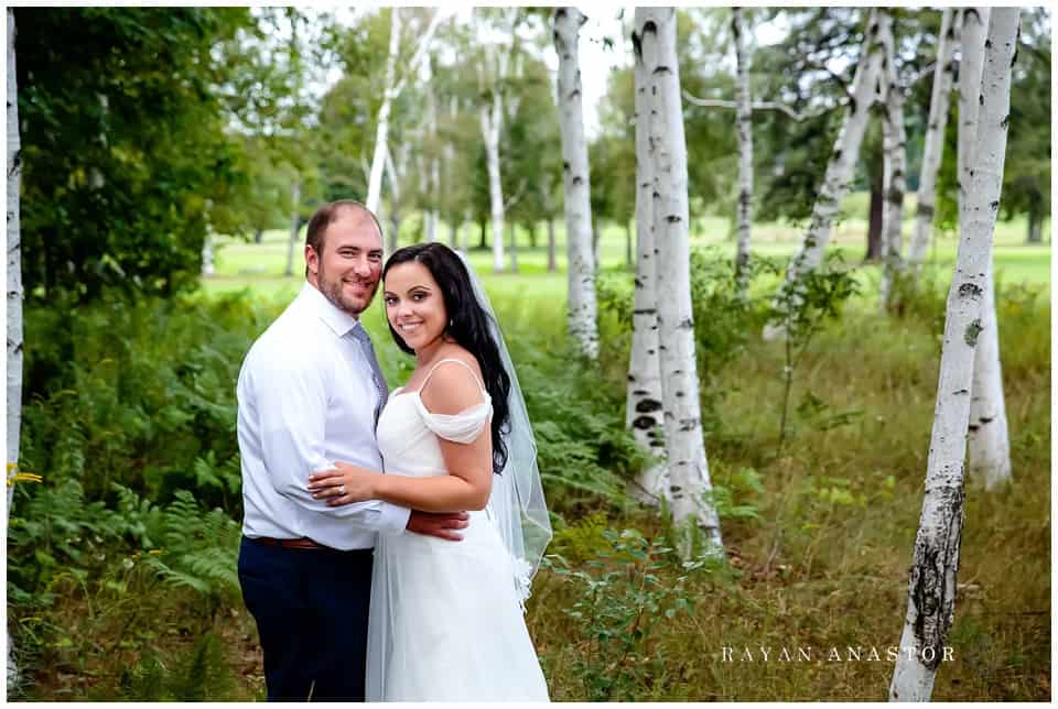 bride and groom among the birch trees