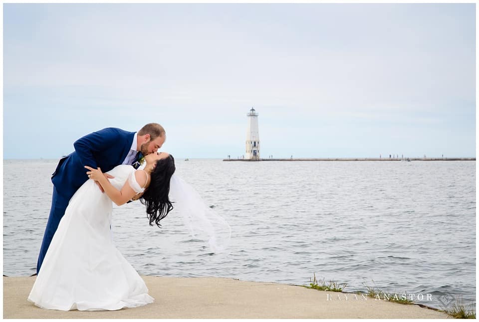 bride and groom overlooking lake michigan