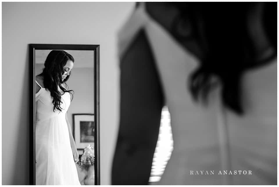 bride getting dressed and ready for beach wedding