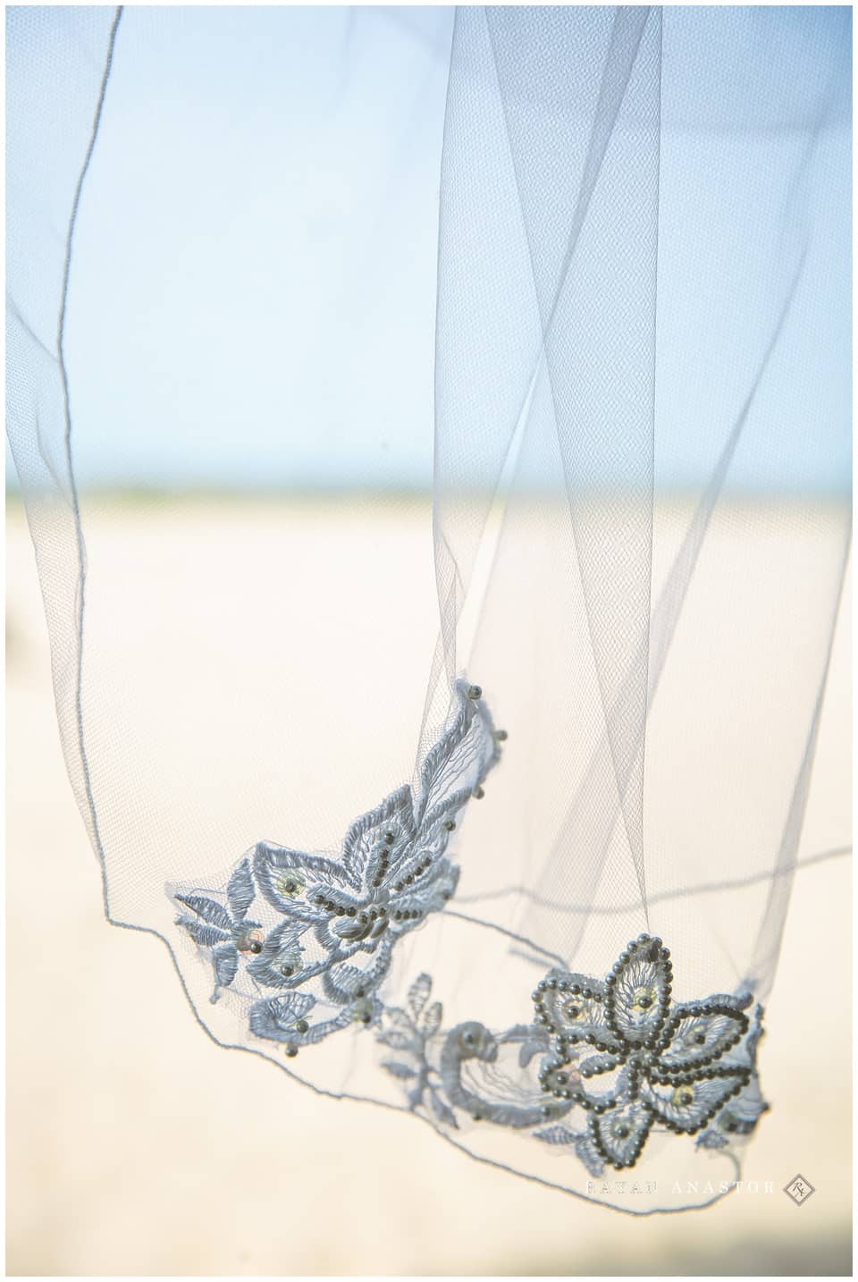 brides veil on beach with lake 