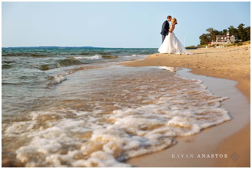 sunset on lake michigan after wedding of bride and groom and water