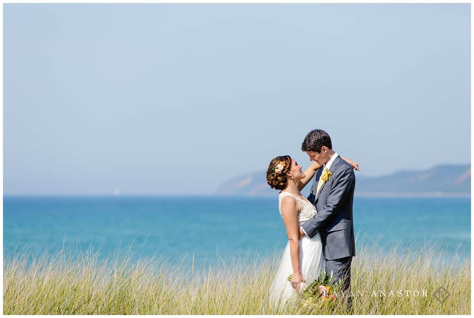 bride and groom in the dune grass on lake michigan