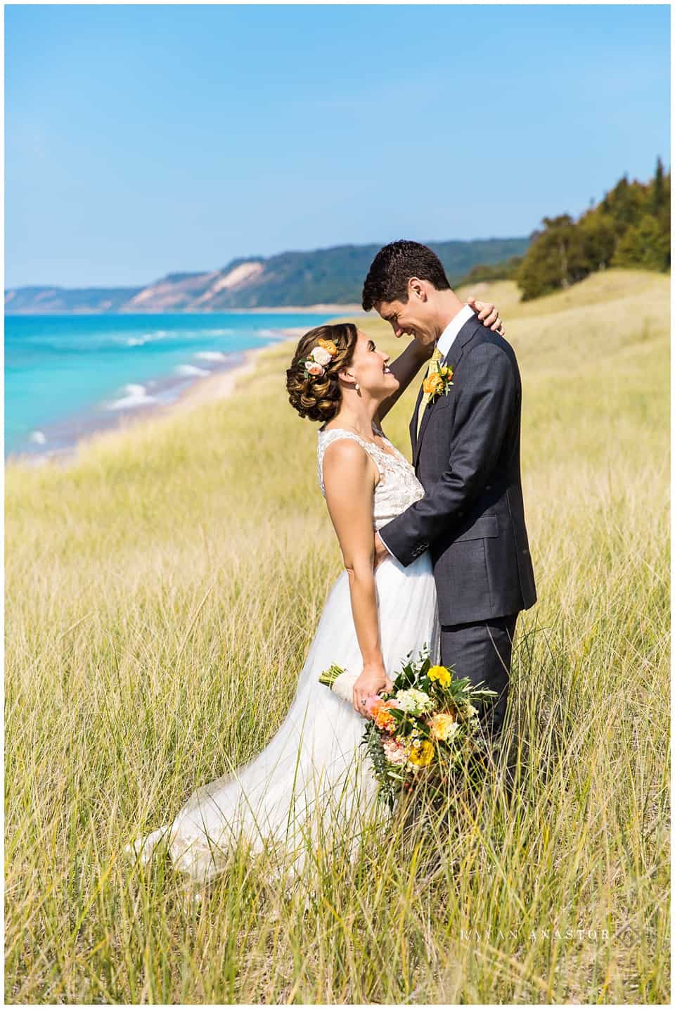 bride and groom on lake michigan in Arcadia