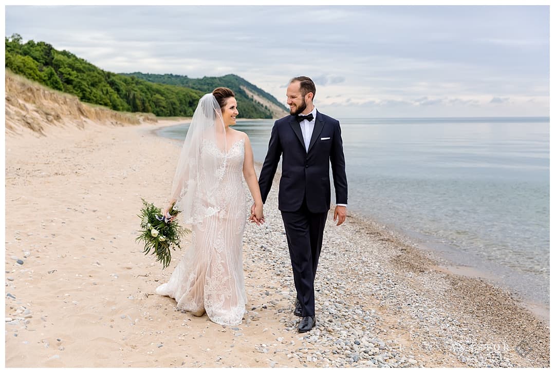 bride and groom walking on a Lake Michigan beach