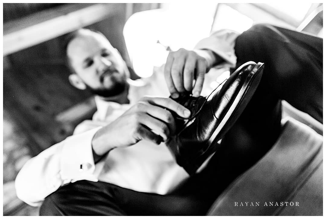 groom putting on shoes