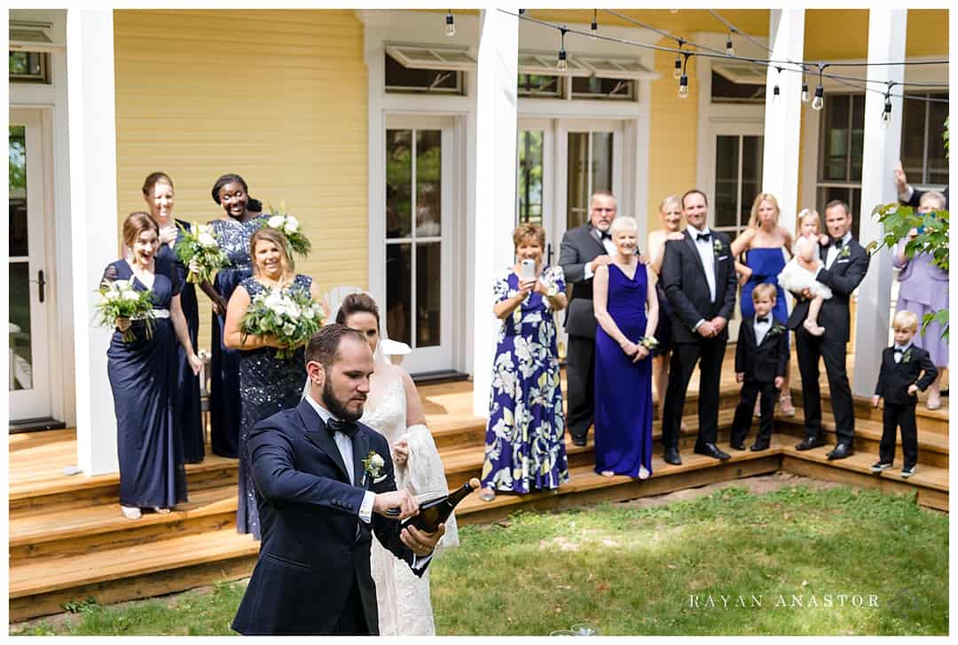 Groom sabering wine bottle to begin celebration