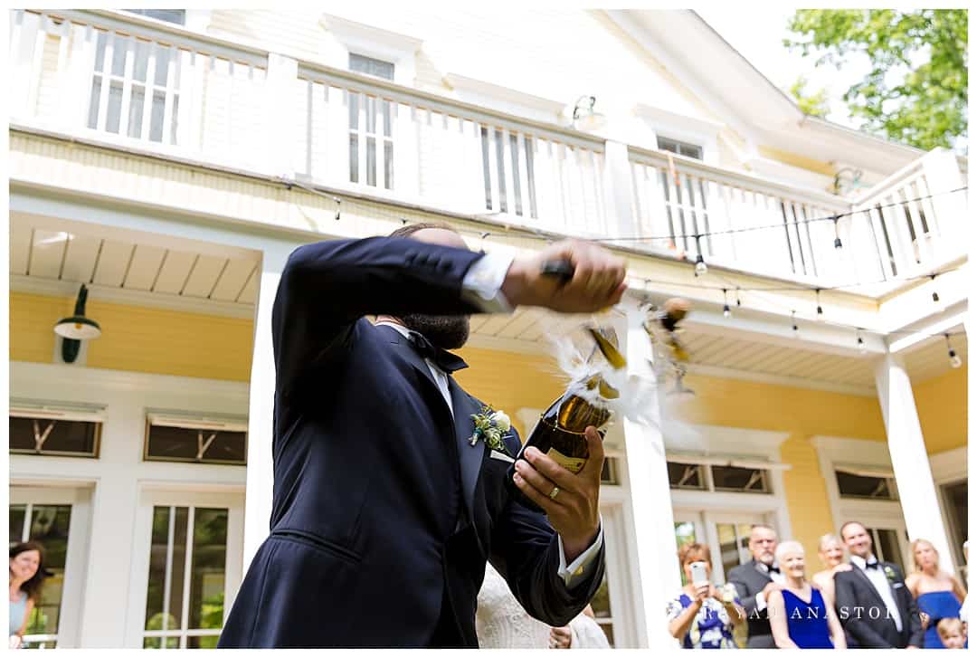 the sabering of a wine bottle at a wedding