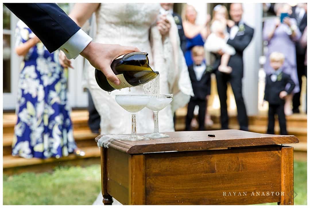 groom pouring champaign for toasts