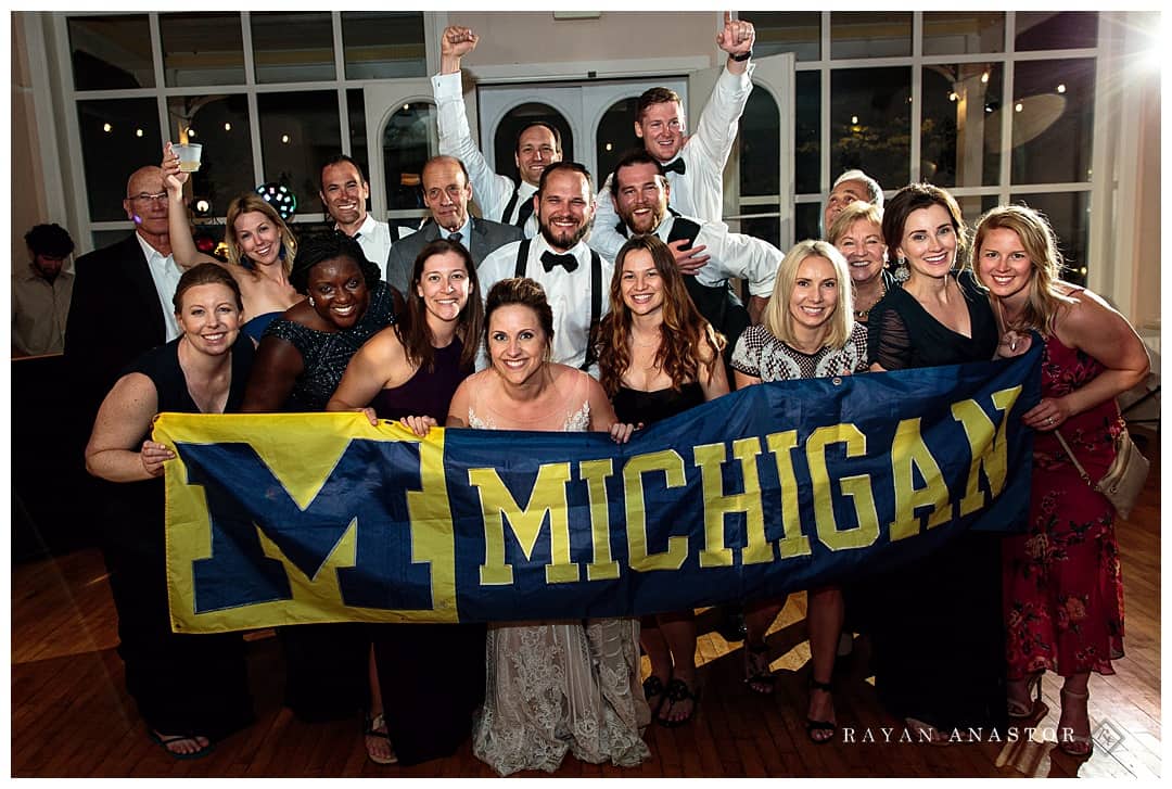 university of Michigan alumni at wedding reception with flag