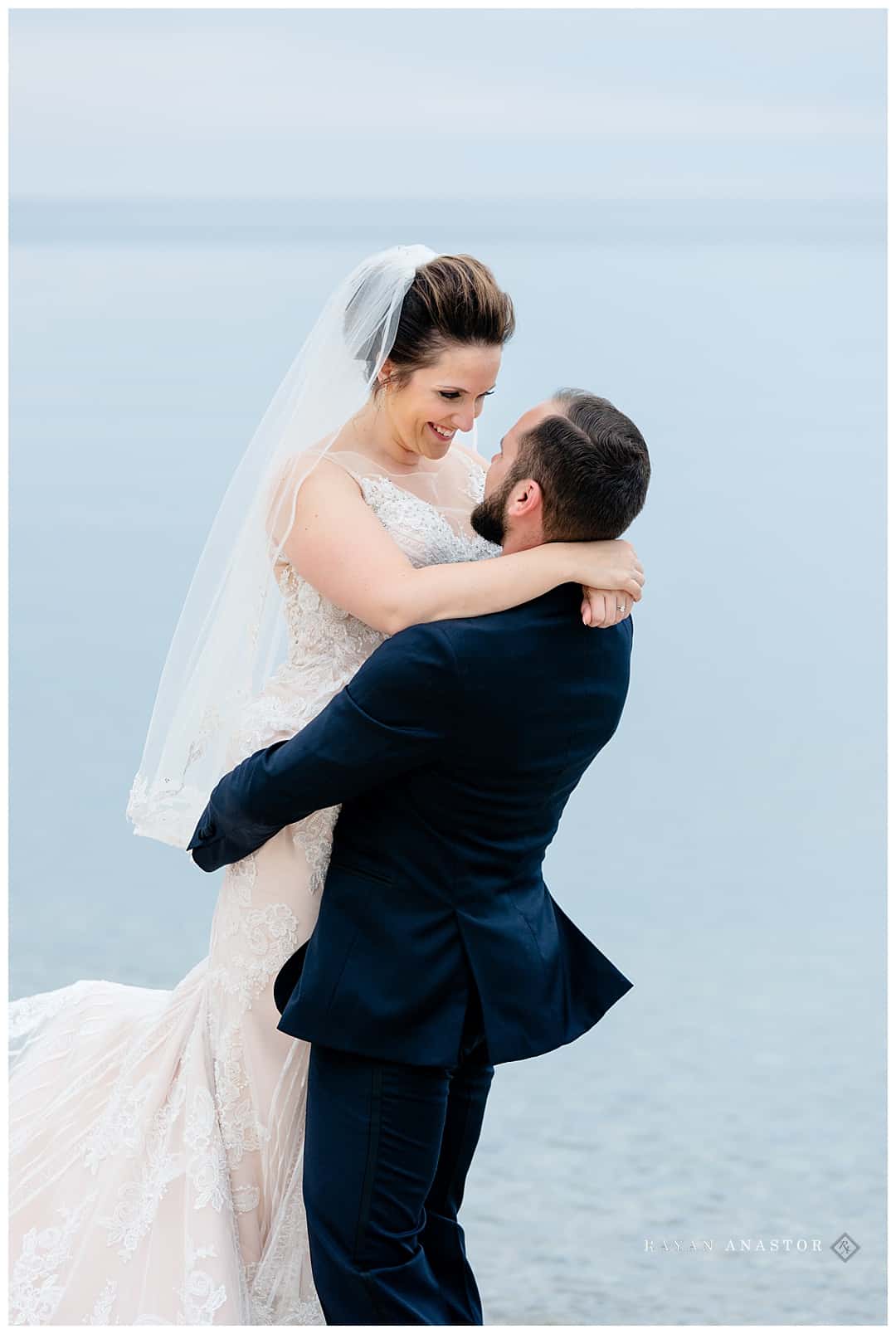 groom twirling bride on beach