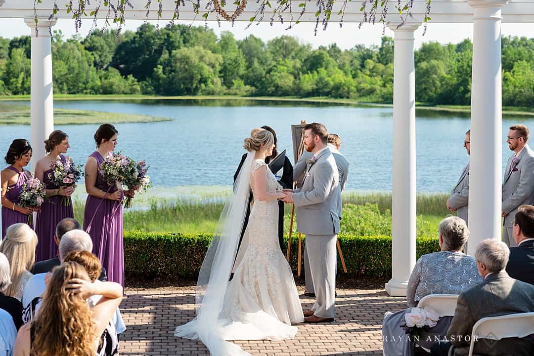 married in front of lake on golf course