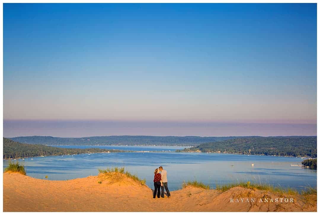 Couple in sand dunes overlooking Little Glen Lake
