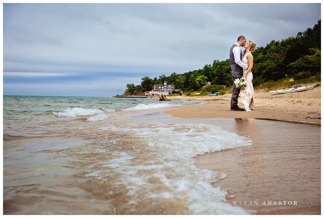 bride and groom on a Lake Michigan beach by Cafe Manitou
