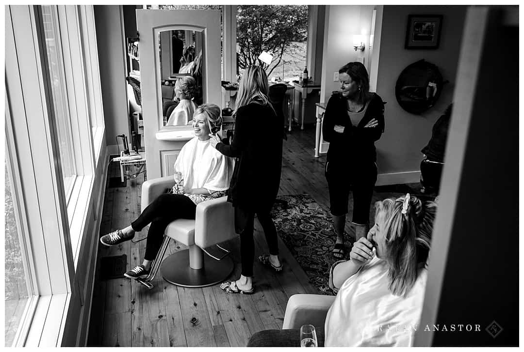 bride getting hair and makeup done at salon in northern Michigan