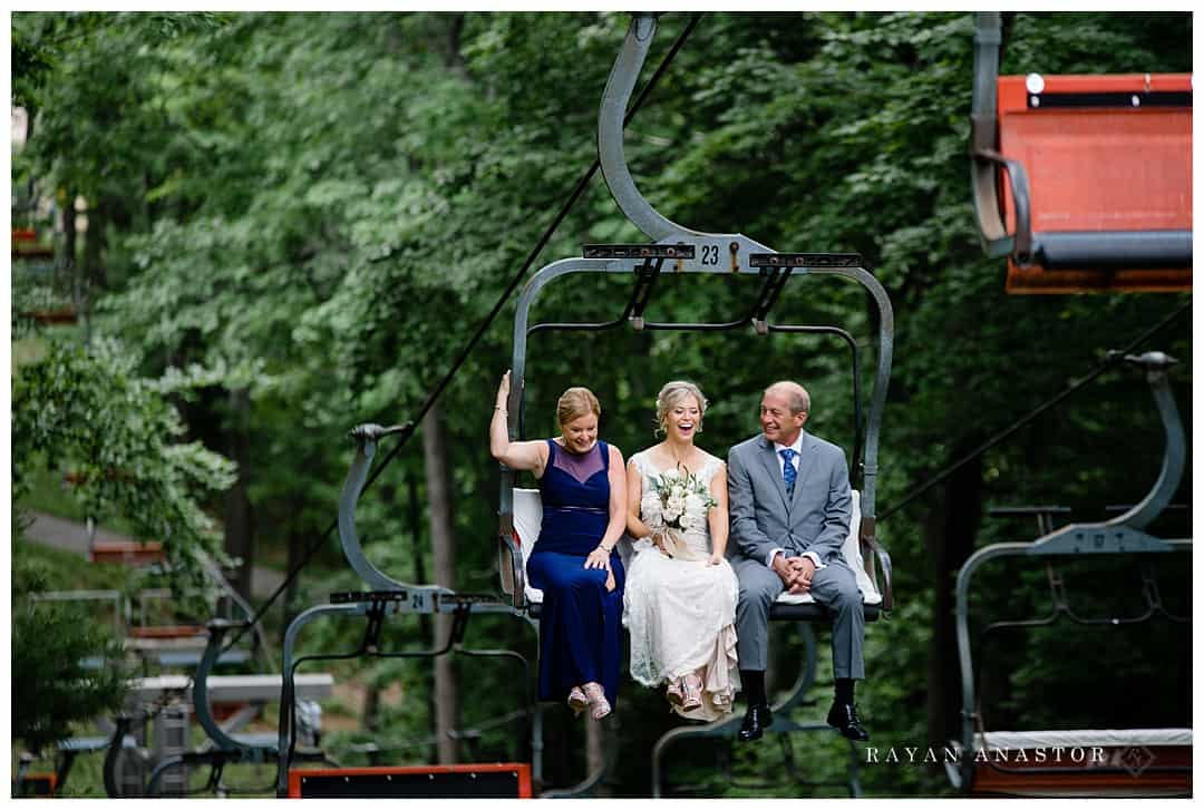 bride riding ski lift to wedding