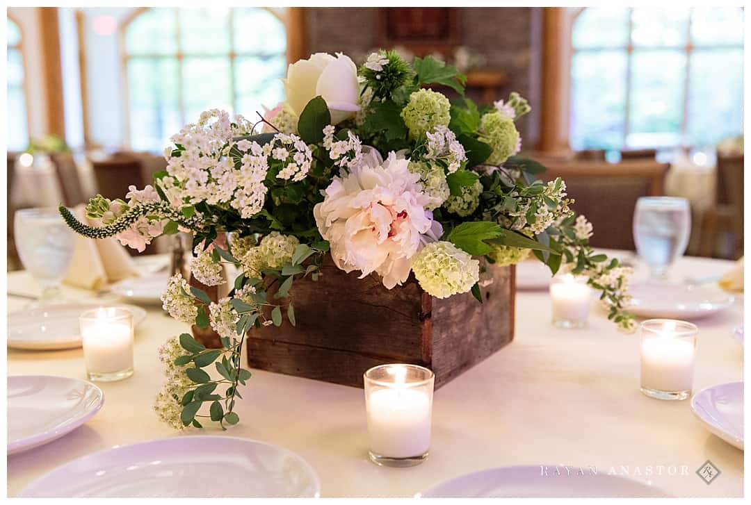 pink and white wedding flowers in box on table