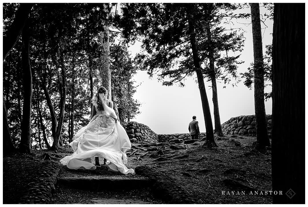 bride walking to groom for first look on sunset rock