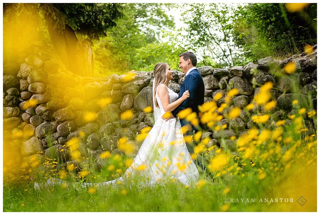 bride and groom in daisy flowers