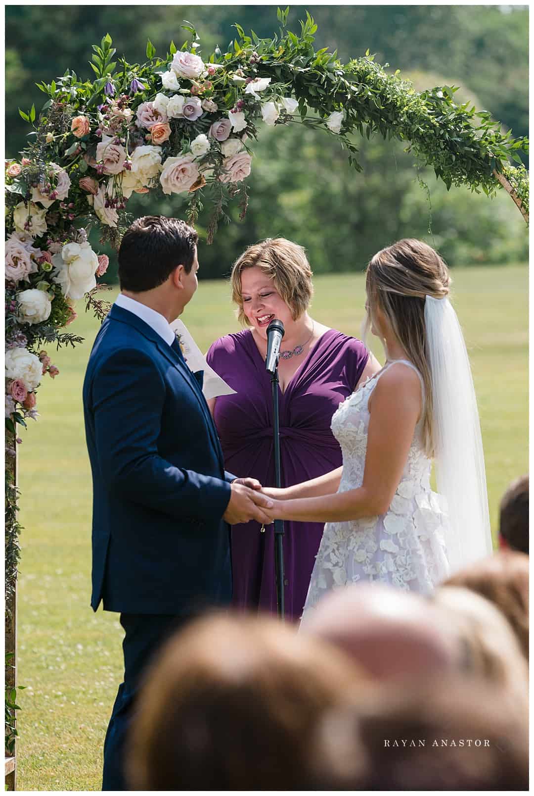outdoor wedding with floral arch