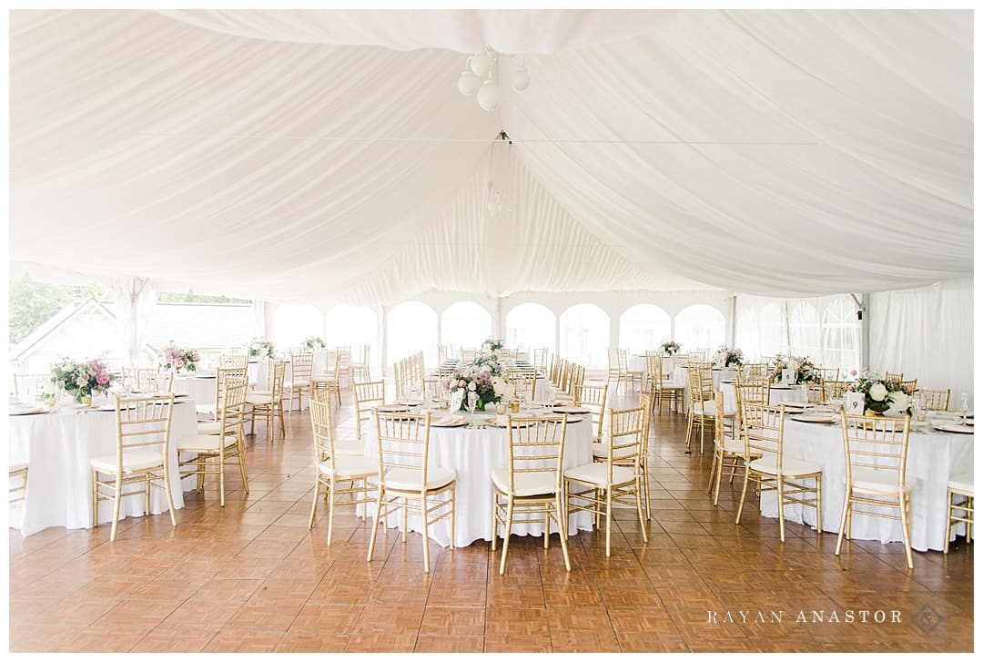 white wedding reception tent with gold and pink florals by bloom floral design