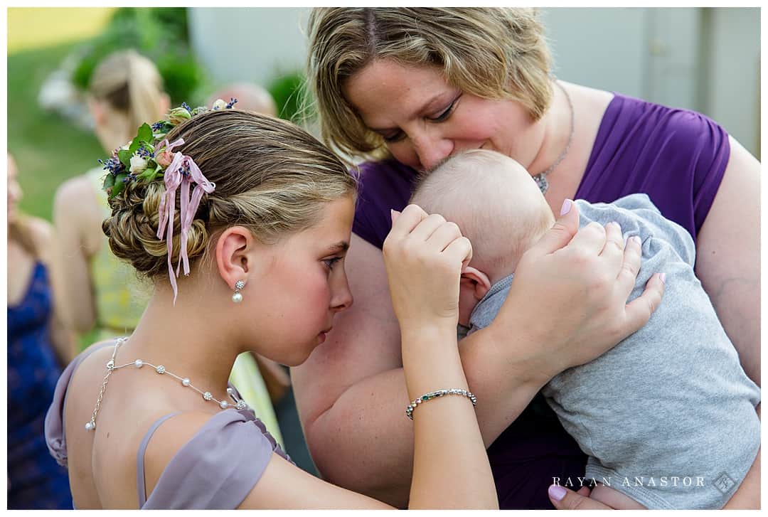 snuggles for a baby at a wedding