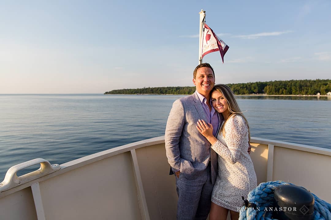 bride and groom enjoying sunset boat cruise around Mackinac Island