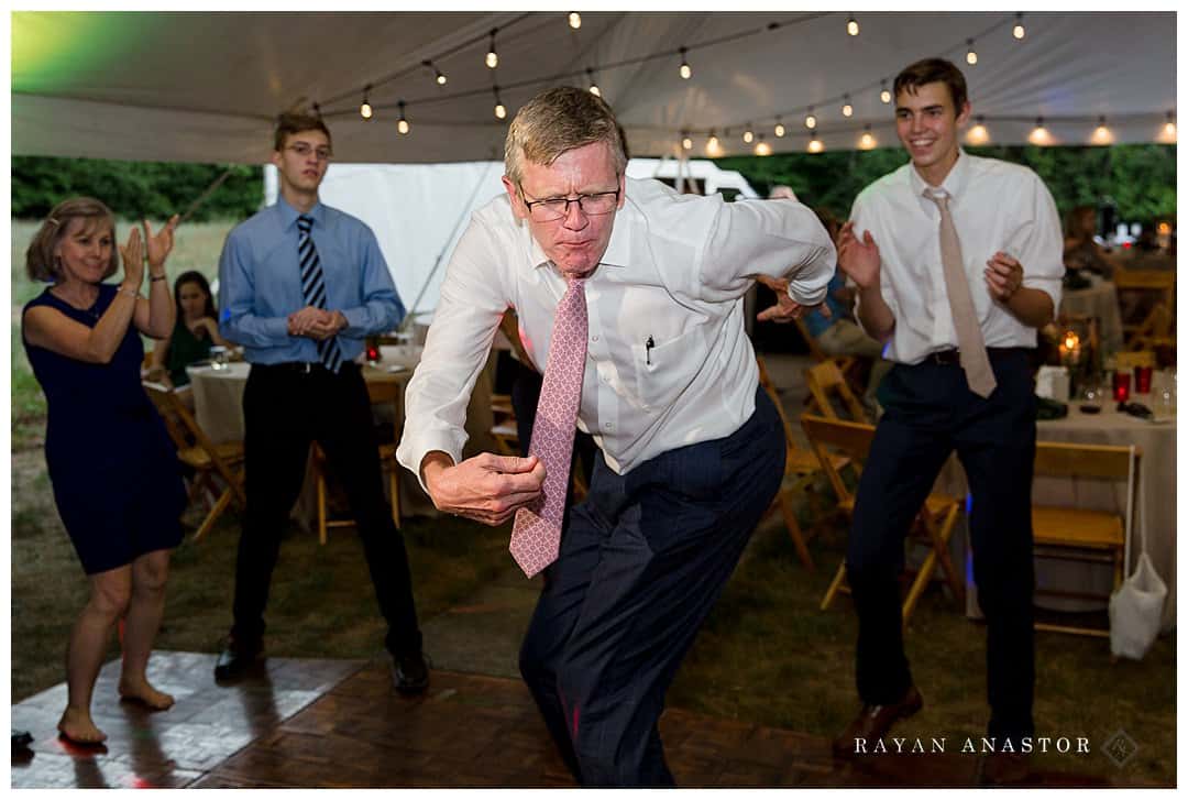 father of bride dancing at reception