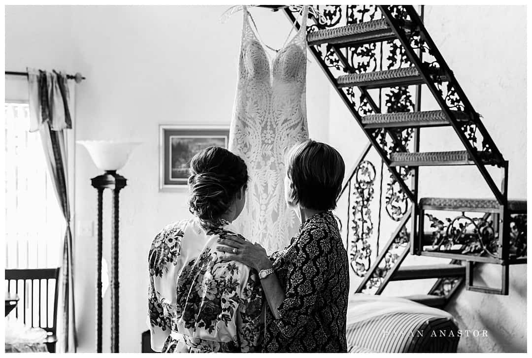 mom and daughter looking at wedding gown