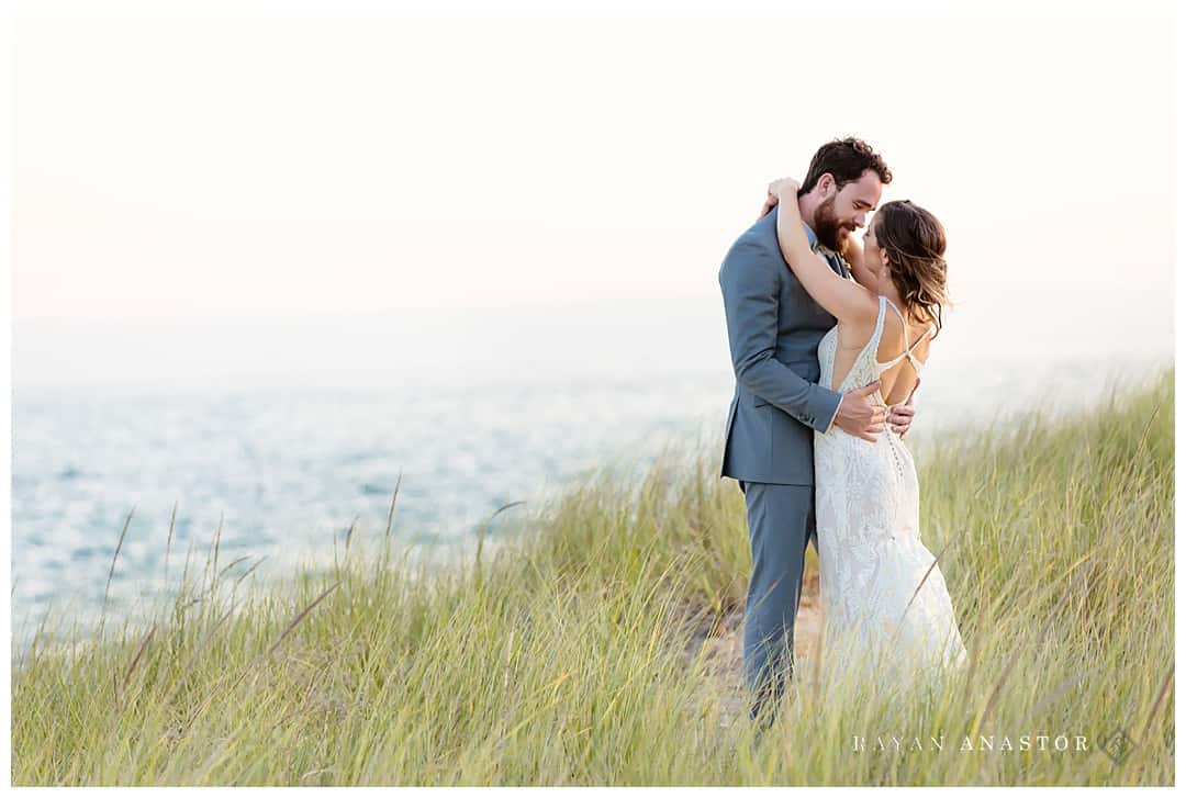 bride and groom at sunset on Lake Michigan dune grass