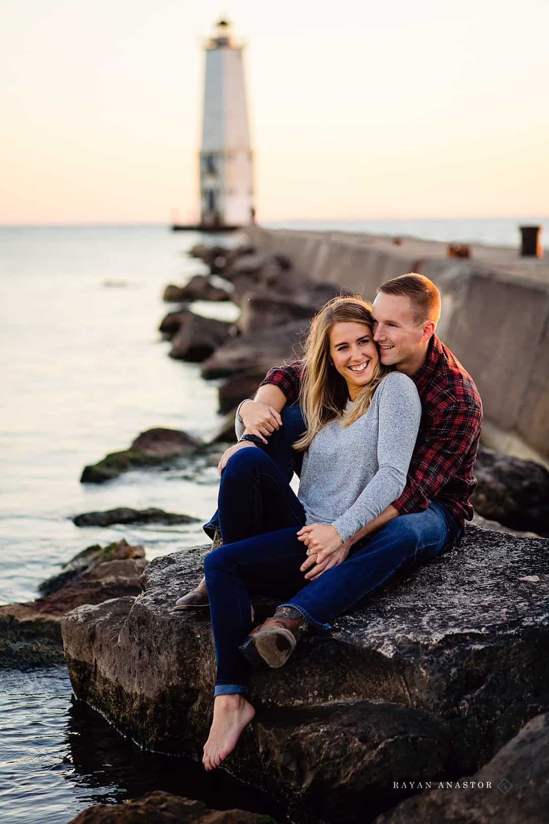 engagement photos on rocks by pier