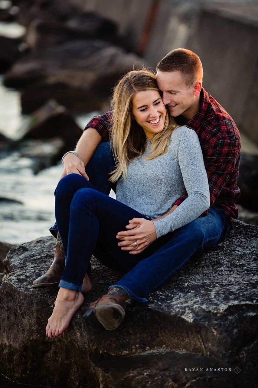 engagement photos on rocks by pier