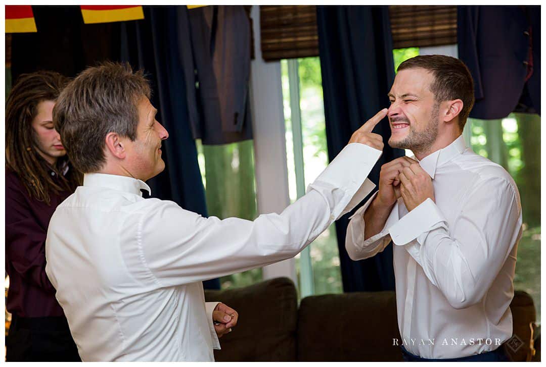 dad messing with groom getting dressed