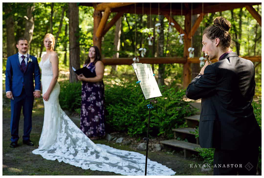 brother playing flute at wedding