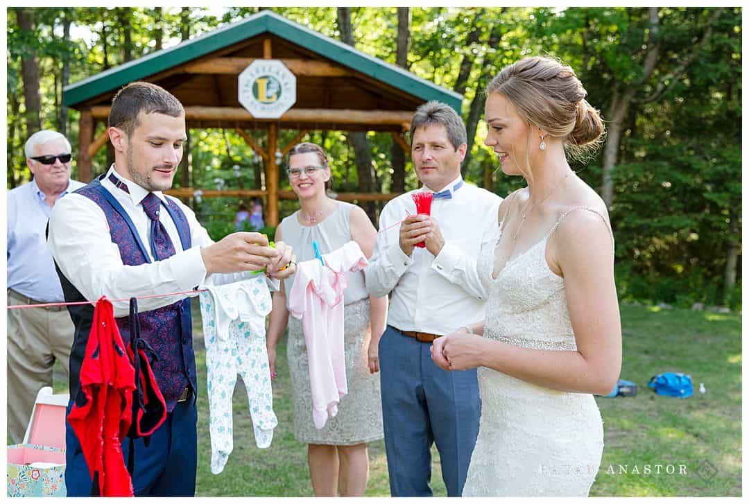 hanging baby clothing on lines at German wedding